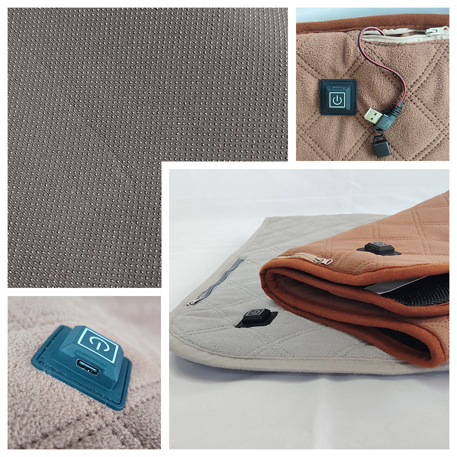 USB heated sleeping pad detail with buttons, USB connection, and textured fabric.